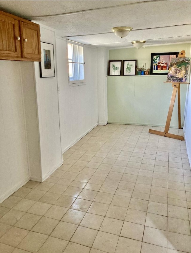 basement featuring light tile patterned floors