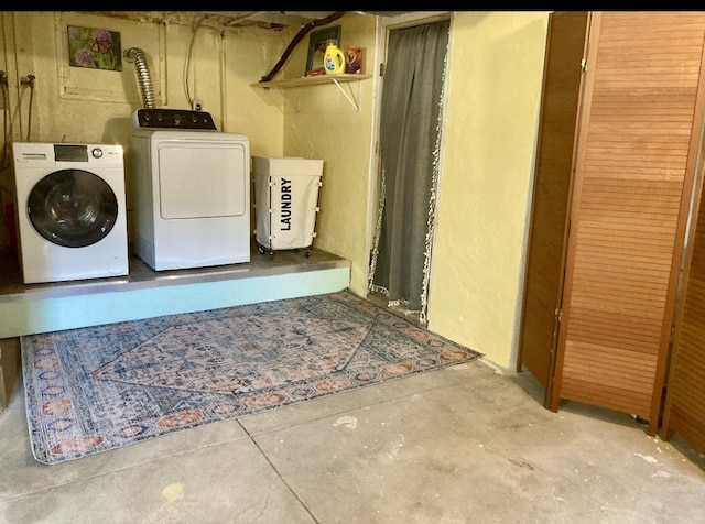 washroom featuring washing machine and clothes dryer and laundry area