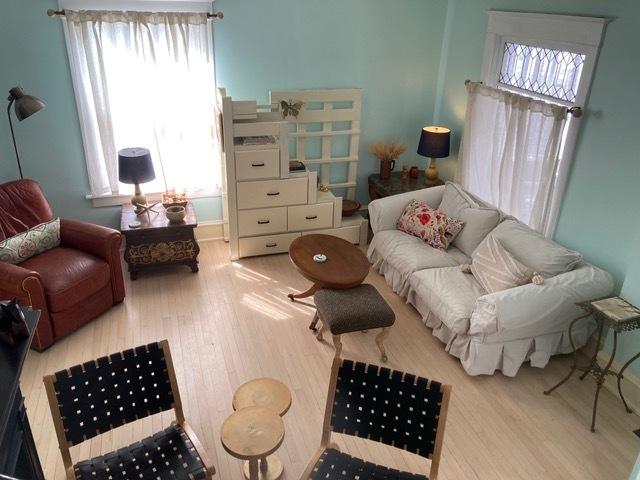 living room with a wealth of natural light and wood finished floors
