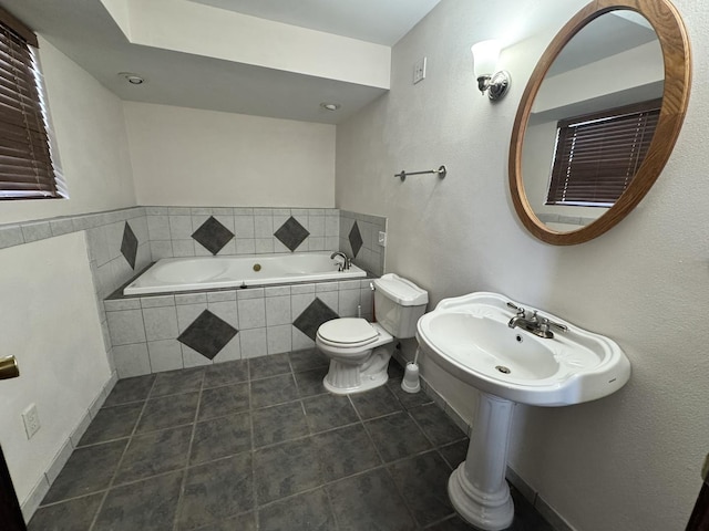 full bath with toilet, tile patterned floors, and a bath