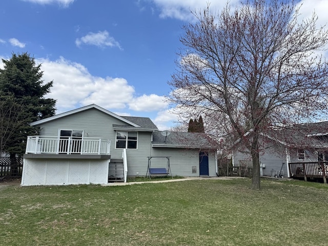 rear view of property featuring a wooden deck, a chimney, and a lawn