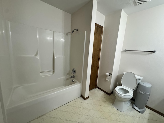 full bath with tile patterned floors, toilet, baseboards, and shower / washtub combination