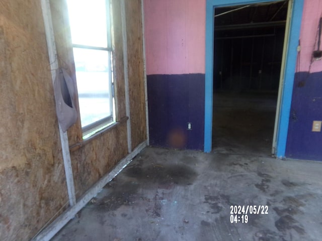 unfurnished room featuring unfinished concrete floors