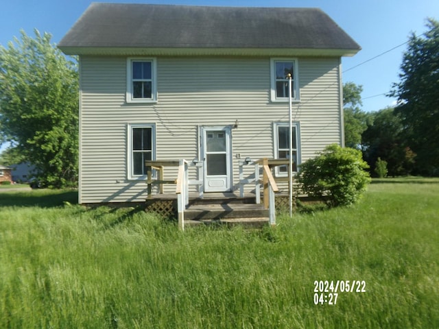 rear view of property featuring a wooden deck