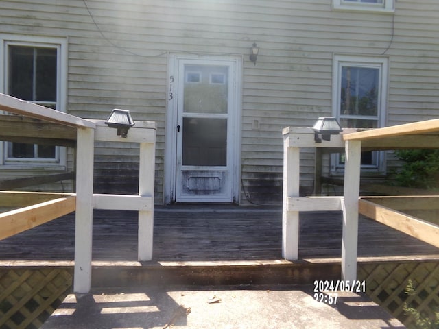 view of exterior entry featuring a wooden deck