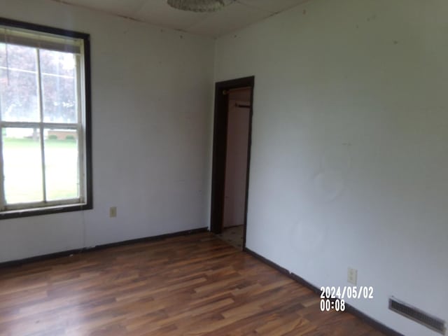 empty room featuring wood finished floors and baseboards