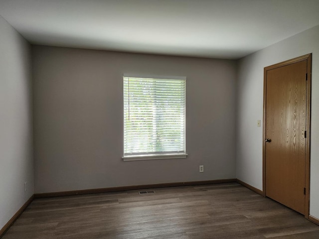 empty room with wood finished floors and baseboards