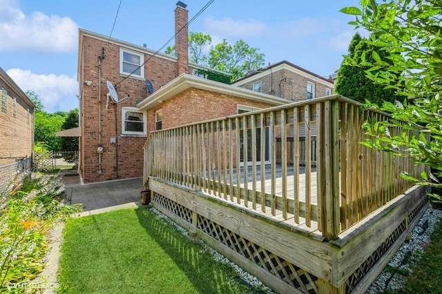 5116 N New England Ave, Chicago, IL 60656 - back of house featuring brick siding, a wooden deck, and a chimney