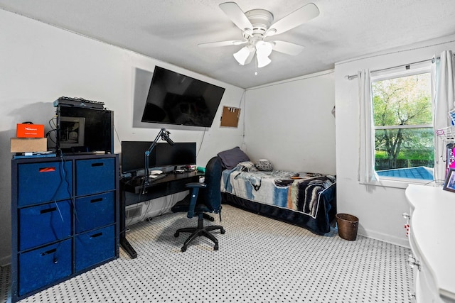 bedroom featuring baseboards and a ceiling fan