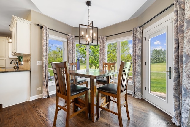 2401 Legacy Dr, Aurora, IL 60502 - dining area with a chandelier, dark wood finished floors, and baseboards