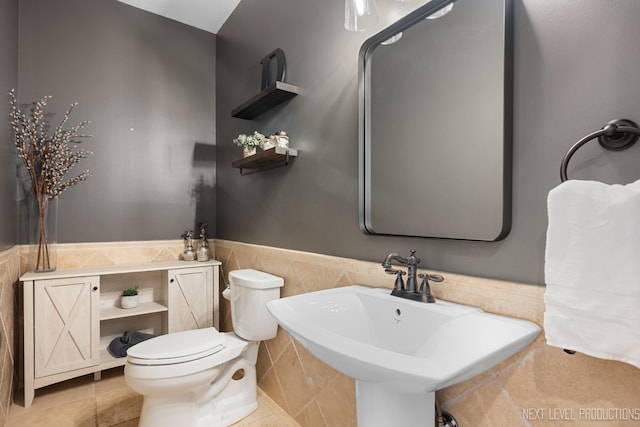 2401 Legacy Dr, Aurora, IL 60502 - half bath with toilet, tile walls, wainscoting, and a sink