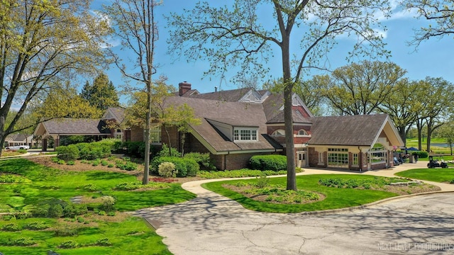 2401 Legacy Dr, Aurora, IL 60502 - view of front facade with a chimney and a front yard