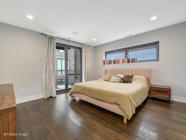 bedroom with wood finished floors, visible vents, baseboards, and access to exterior