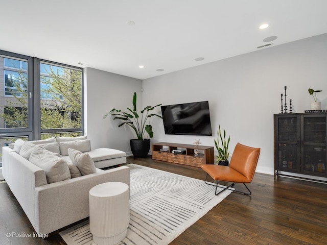 living room with baseboards, recessed lighting, visible vents, and wood finished floors