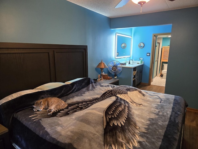 bedroom with light wood-style floors, baseboards, ceiling fan, and a sink