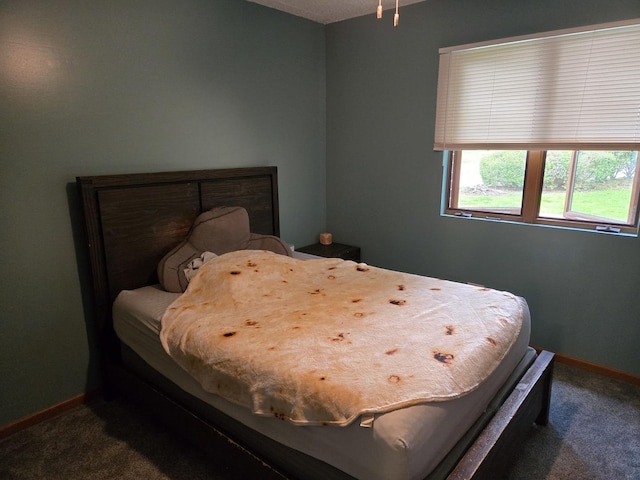 carpeted bedroom featuring baseboards
