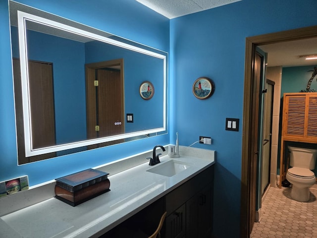 bathroom featuring toilet and vanity