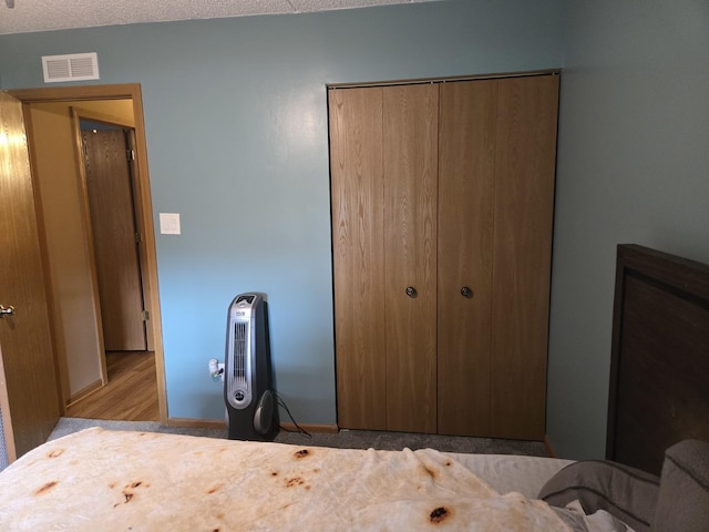 bedroom featuring a closet and visible vents