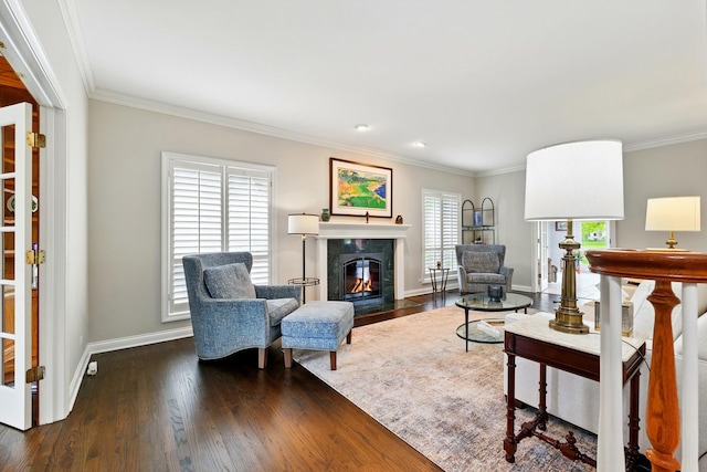 living area featuring dark wood-style flooring, baseboards, a high end fireplace, and crown molding