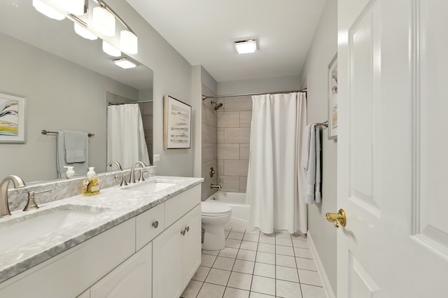 bathroom with tile patterned flooring, double vanity, toilet, shower / bath combo, and baseboards