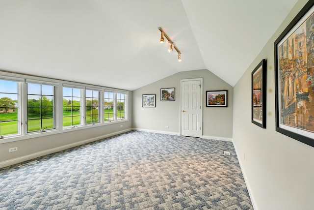 bonus room with lofted ceiling, baseboards, and carpet