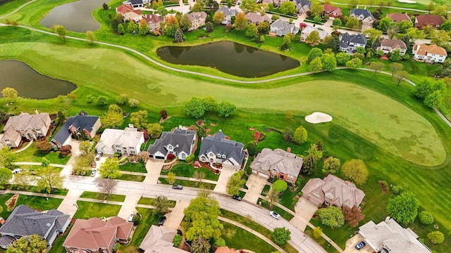 aerial view of residential area featuring a large body of water and a local golf course