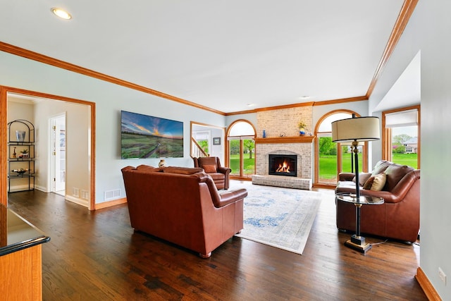 living area with baseboards, dark wood finished floors, crown molding, a brick fireplace, and recessed lighting