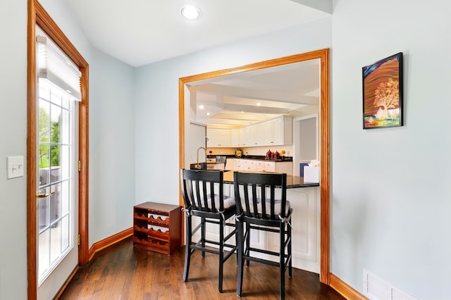 dining area with baseboards, dark wood-style floors, and recessed lighting