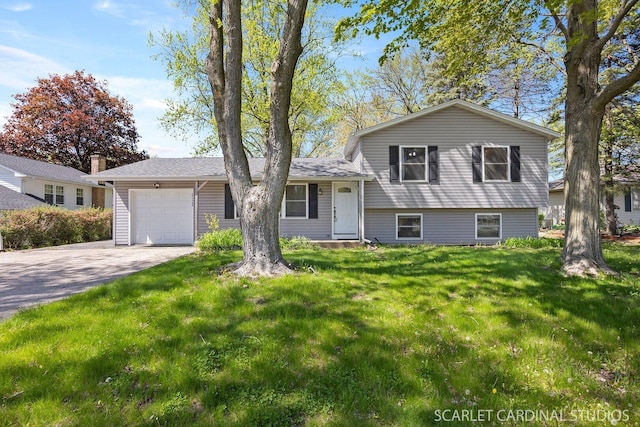 split level home featuring an attached garage, driveway, and a front yard
