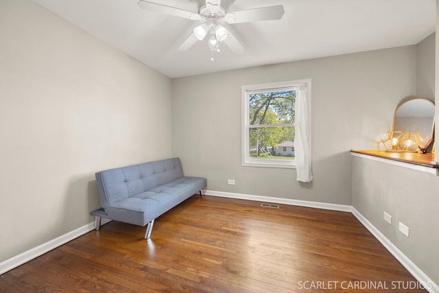 unfurnished room featuring wood finished floors, baseboards, and a ceiling fan