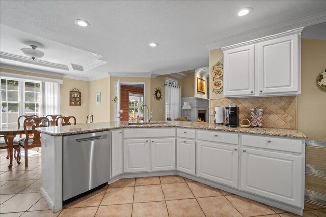 1721 Partridge Pt, Normal, IL 61761 - kitchen with stainless steel dishwasher, ornamental molding, a sink, backsplash, and white cabinetry