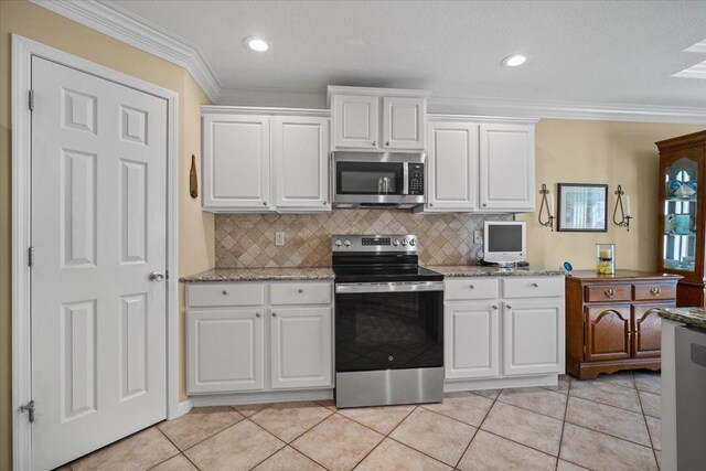 1721 Partridge Pt, Normal, IL 61761 - kitchen featuring stainless steel appliances, white cabinetry, crown molding, backsplash, and light stone countertops