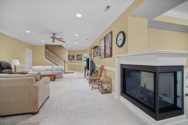 1721 Partridge Pt, Normal, IL 61761 - carpeted living area featuring crown molding, a multi sided fireplace, stairway, recessed lighting, and ceiling fan