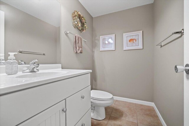 1721 Partridge Pt, Normal, IL 61761 - half bathroom featuring vanity, toilet, baseboards, and tile patterned floors