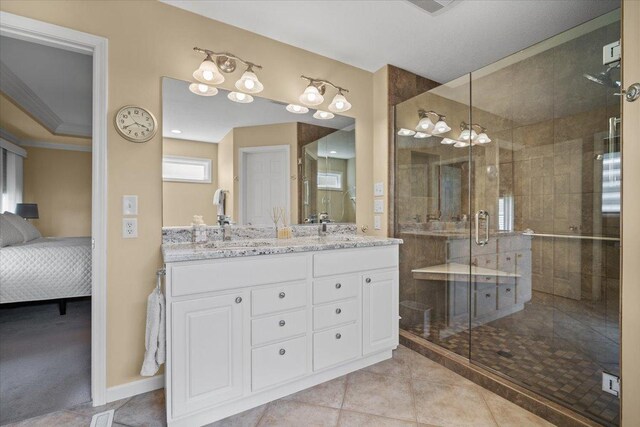 1721 Partridge Pt, Normal, IL 61761 - ensuite bathroom featuring a shower stall, tile patterned flooring, double vanity, and baseboards