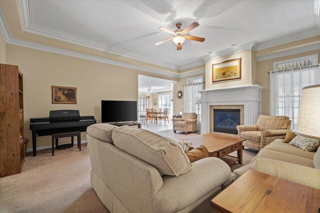 1721 Partridge Pt, Normal, IL 61761 - living room featuring ceiling fan, crown molding, a glass covered fireplace, light carpet, and baseboards