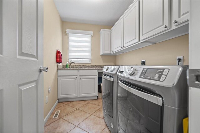 1721 Partridge Pt, Normal, IL 61761 - laundry room featuring cabinet space, washer and dryer, light tile patterned floors, and baseboards