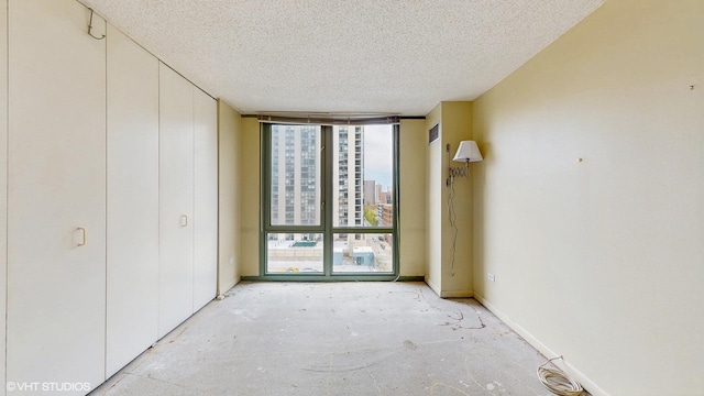 111 W Maple St Unit 1001, Chicago, IL 60610 - unfurnished bedroom with multiple windows, a textured ceiling, and expansive windows