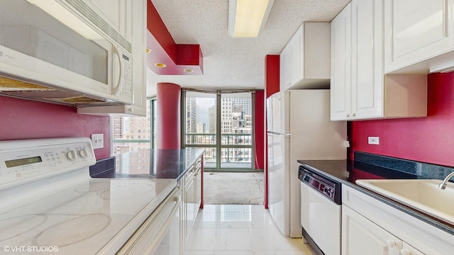 111 W Maple St Unit 1001, Chicago, IL 60610 - kitchen featuring white appliances, a textured ceiling, white cabinetry, light tile patterned floors, and a sink