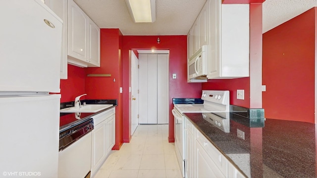 111 W Maple St Unit 1001, Chicago, IL 60610 - kitchen featuring white appliances, a sink, white cabinetry, a textured ceiling, and dark stone counters