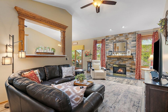 living room with a healthy amount of sunlight, wood finished floors, lofted ceiling, and ceiling fan