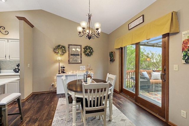 dining space featuring lofted ceiling, baseboards, dark wood finished floors, and a chandelier