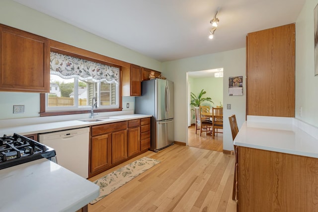 19 S 11th St, Saint Charles, IL 60174 - kitchen with freestanding refrigerator, white dishwasher, a sink, brown cabinetry, and light countertops