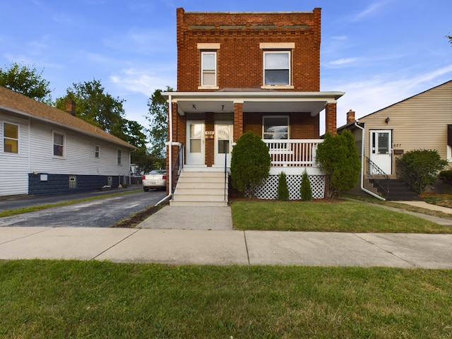 625 Ingraham Ave, Calumet City, IL 60409 - view of front of house featuring brick siding, a front yard, and a porch