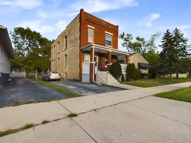 625 Ingraham Ave, Calumet City, IL 60409 - view of front facade with covered porch, brick siding, and driveway