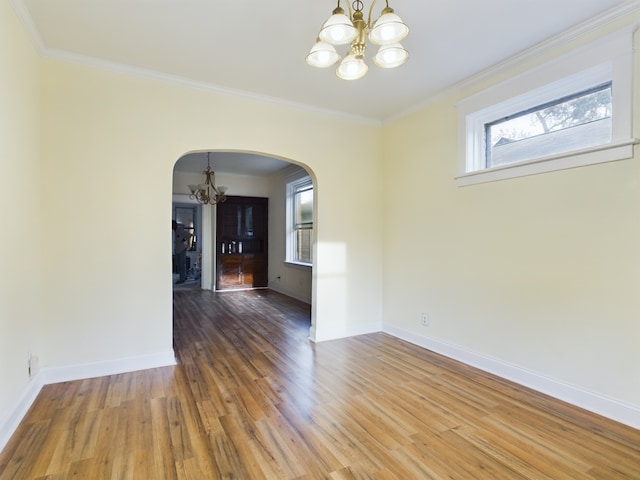 625 Ingraham Ave, Calumet City, IL 60409 - empty room with wood finished floors, a chandelier, crown molding, arched walkways, and baseboards