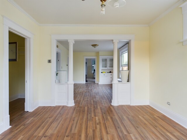 625 Ingraham Ave, Calumet City, IL 60409 - spare room featuring crown molding, baseboards, wood finished floors, and decorative columns