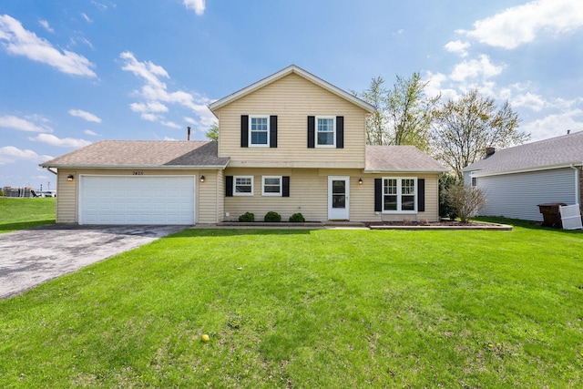 view of front of house with a front lawn, aphalt driveway, and a garage