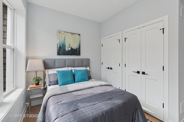 847 W Ainslie St Unit 2E, Chicago, IL 60640 - bedroom with multiple closets and wood finished floors