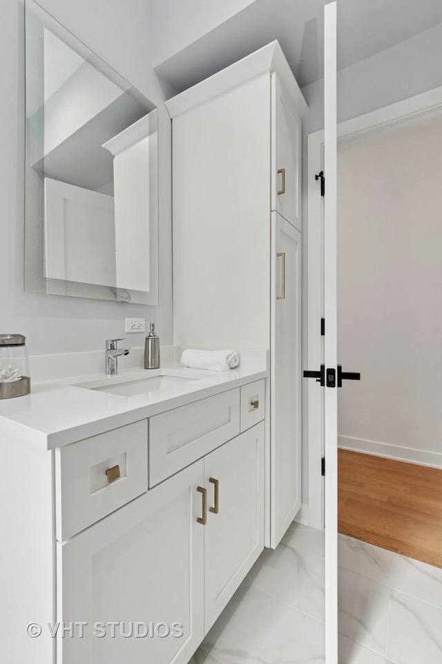 847 W Ainslie St Unit 2E, Chicago, IL 60640 - bathroom featuring marble finish floor, baseboards, and vanity